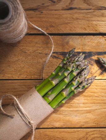 Close-up of fresh green asparagus on wooden background, top viewの写真素材