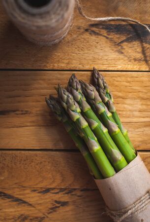 Close-up of fresh green asparagus on wooden background, top viewの写真素材