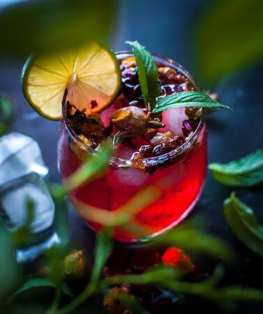 Close-up of homemade flower ice tea in a glass with fresh mint, on dark backgroundの写真素材