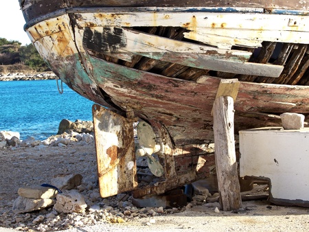 old rusty propeler on a rotten old boatの写真素材