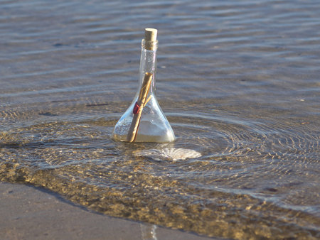 sealed message in the bottle on the sand beach