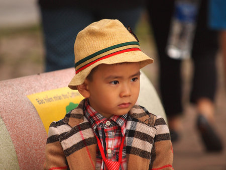 HO CHI MINH CITY, VIET NAM- FEB16:,Portrait of a handsome Asian  boy on traditional tet festival costume. Cute little Vietnamese boy  in ao dai dress smiling. Tet holiday. Lunar New Year Vietnam, Feb 16, 2015のeditorial素材