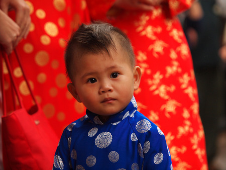 HO CHI MINH CITY, VIET NAM- FEB16:,Portrait of a handsome Asian  boy on traditional festival costume. Cute little Vietnamese boy  in ao dai dress smiling. Tet holiday. Lunar New Year Vietnam, Feb 16, 2015のeditorial素材