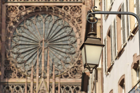 Old street lamp with Notre Dame in Strasbourg in the background, Franceの写真素材