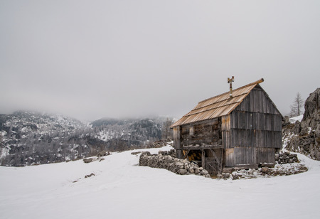 Traditional wooden shepherd house on alpine meadow in Julian Alps, Sloveniaの写真素材