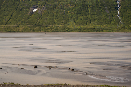 beautiful glacier river in green icelandic landscapeの写真素材