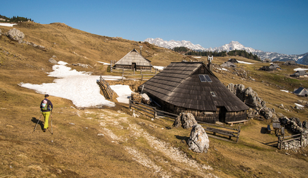Scenic high alpine pasture Velika Planina with traditional old shepherd wooden cottages during spring timeの写真素材