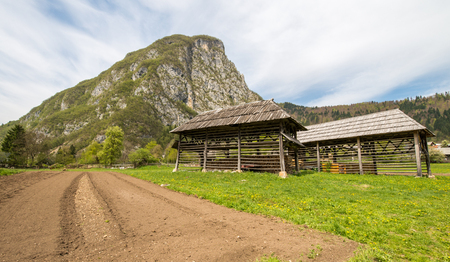 Traditional wooden double hayrack in small village of Studor near Bohinj in Slovenia during spring timeの写真素材