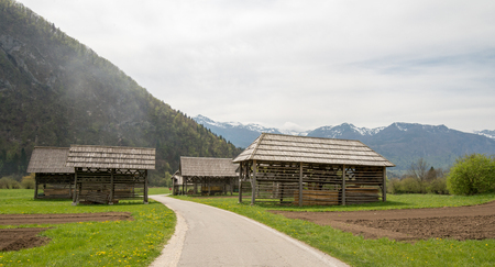 Traditional wooden double hayrack in small village Studor near Bohinj in Slovenia during spring timeの写真素材