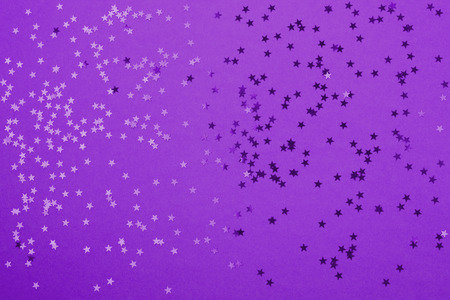 Beautiful festive ultra violet background with metallic star shaped confetti. Holiday or decoration concept.の写真素材
