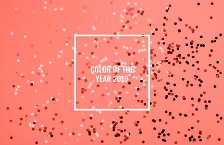 Beautiful festive coral background with confetti. Holiday decoration concept. Place for text. Color of the year 2019. Living coral.の写真素材