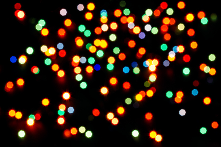 Abstract multicolor bokeh texture on black background. Defocused sparkles.の写真素材