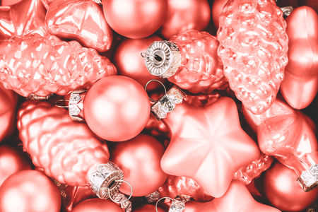 Coral Christmas baubles background. Color trend of the year.の写真素材