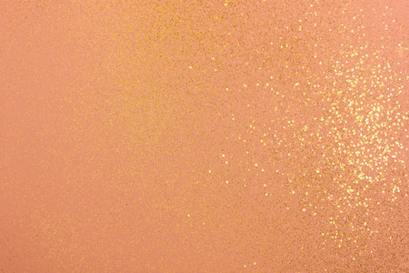 Beautiful light coral background with golden glitter. Holiday decoration concept.の写真素材