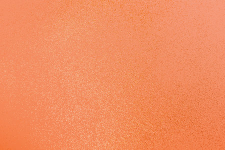 Beautiful light orange background with golden glitter. Holiday decoration concept.の写真素材