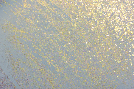 Abstract light gray background with golden glitter. Holiday decoration concept. Place for text.の写真素材