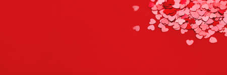 Beautiful festive with red metallic heart shaped confetti.の写真素材