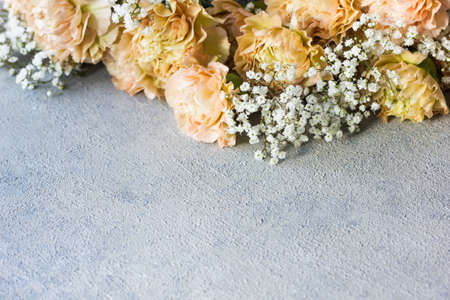 Beige carnation flowers bouquet on gray background.の写真素材