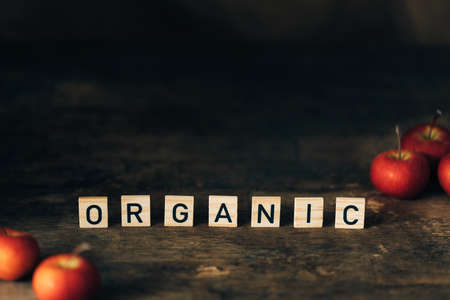 Dark wooden background with wooden letters and farmers apples.の写真素材