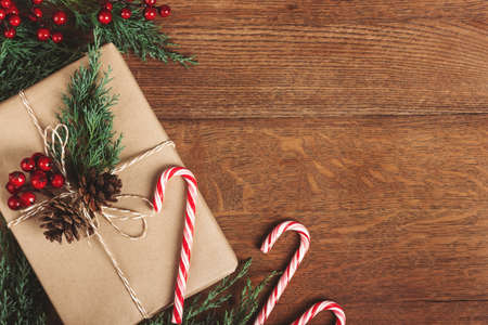 Gift box with winter decor on wooden table.の写真素材