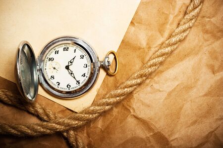 antique watch and rope on old yellow paperの写真素材