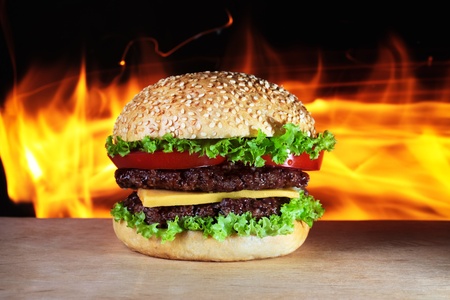 big hamburger with real fire on a backgroundの写真素材