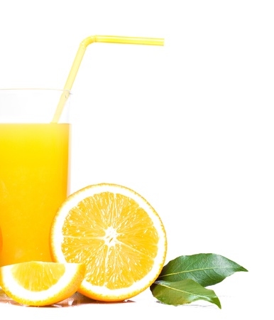 orange with green leaves and glass of juiceの写真素材