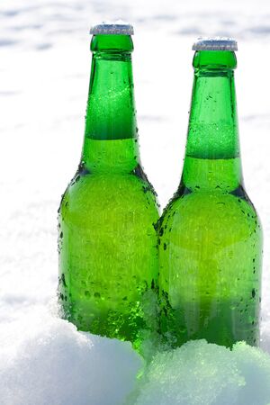 beer bottles in snowの写真素材