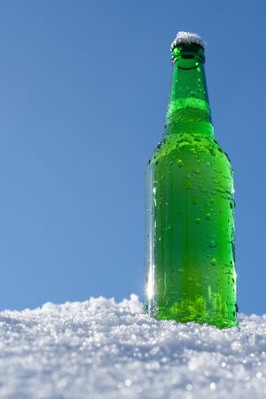 beer bottle in snowの写真素材