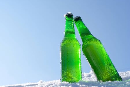 beer bottles in snowの写真素材