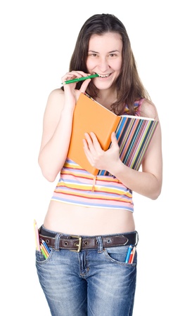 smiling girl with notebook biting pencilの写真素材