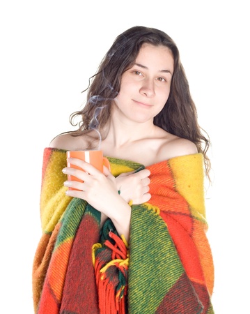 sleepy smiling girl rolled in a rug drinks hot teaの写真素材