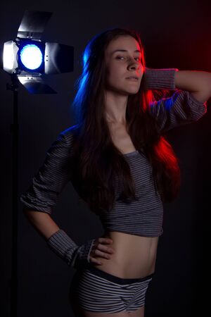 girl with colored studio flashes on backgroundの写真素材