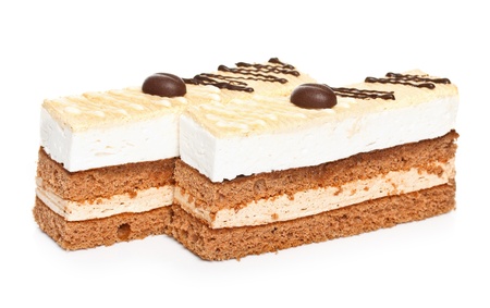 Slice of cappuccino cake isolated on whiteの写真素材