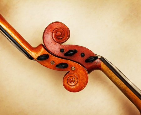 two old violin scrolls detail in ambient lightの写真素材