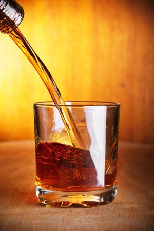 whiskey being poured into a glassの写真素材