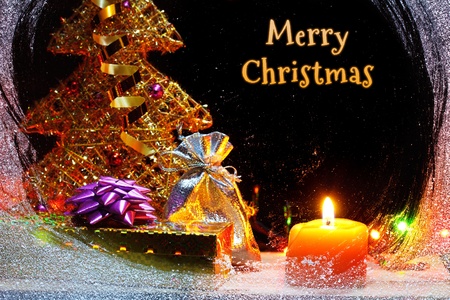 Merry Christmas still-life with christmas gifts behind snowy windowの写真素材