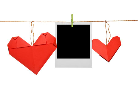 Blank photo frame with origami hearts on ropeの写真素材