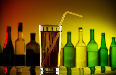 Alcohol cocktail with straw on barの写真素材