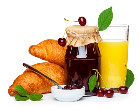 Cherry jam with croissants and juiceの写真素材