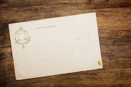 Retro 1900th postcard on wooden tableの写真素材