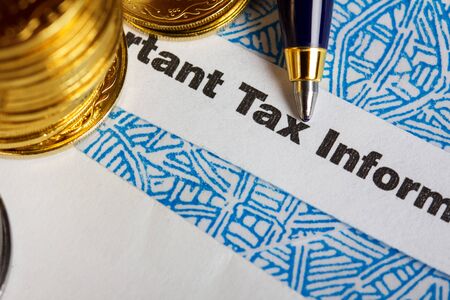Tax form with coins and penの写真素材