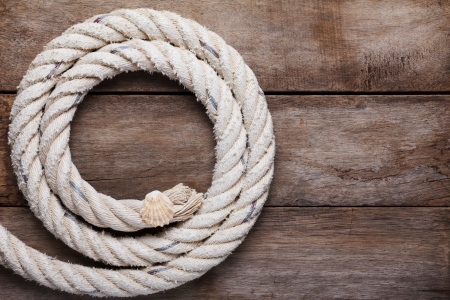 Sea rope with shell on wooden backgroundの写真素材