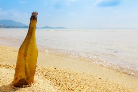 Bottle with a message on tropical islandの写真素材