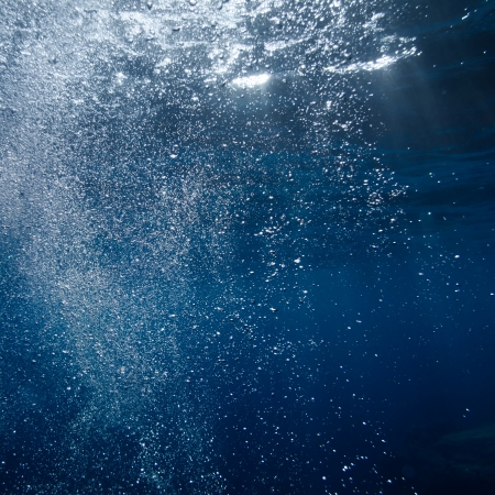 Underwater bubble shot in deep blue tropical seaの写真素材