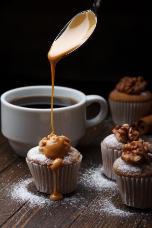 Cupcake with nuts and flowing caramelの写真素材