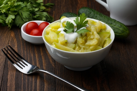 Bowl of prepared zucchini on wooden tableの写真素材