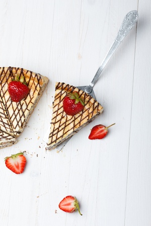 Slice of cheesecake with strawberry on cake lifterの写真素材