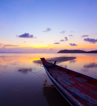 Sunset over sea with small wooden boat, Thailandの写真素材