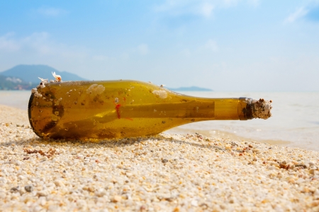 Bottle with a message on tropical shoreの写真素材